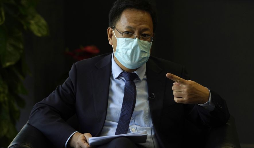 Xu Guixiang, the deputy director-general of the Xinjiang Communist Party publicity department, speaks during an interview in Beijing Monday, Dec. 21, 2020. The Chinese Communist Party official signaled Monday that there would likely be no let-up in its crackdown in the Xinjiang region, but said the government's focus is shifting more to addressing the roots of extremism. (AP Photo/Ng Han Guan)