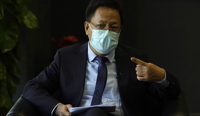 Xu Guixiang, the deputy director-general of the Xinjiang Communist Party publicity department, speaks during an interview in Beijing Monday, Dec. 21, 2020. The Chinese Communist Party official signaled Monday that there would likely be no let-up in its crackdown in the Xinjiang region, but said the government's focus is shifting more to addressing the roots of extremism. (AP Photo/Ng Han Guan)