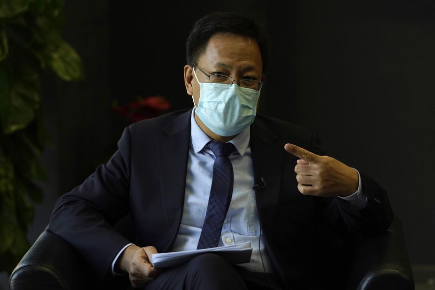 Xu Guixiang, the deputy director-general of the Xinjiang Communist Party publicity department, speaks during an interview in Beijing Monday, Dec. 21, 2020. The Chinese Communist Party official signaled Monday that there would likely be no let-up in its crackdown in the Xinjiang region, but said the government's focus is shifting more to addressing the roots of extremism. (AP Photo/Ng Han Guan)