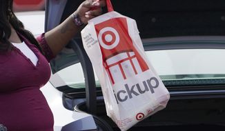 A Target employee places a curbside pickup purchase into the trunk of a customer in Jackson, Miss., Thursday, Nov. 5, 2020.  After a weak start to the holiday season for many mall-based retailers, the strugglers are making their final push in the final days before and the week after Christmas. Many are stepping up discounts while heavily promoting curbside pickup as a way to get shoppers, worried about being infected with  the virus,  to visit their stores. But experts believe that any burst of sales will be too little and too late to save some stores.  (AP Photo/Rogelio V. Solis)