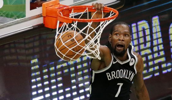 Brooklyn Nets forward Kevin Durant (7) dunks during the second half of an NBA preseason basketball game against the Boston Celtics, Friday, Dec. 18, 2020, in Boston. (AP Photo/Mary Schwalm)