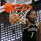 Brooklyn Nets forward Kevin Durant (7) dunks during the second half of an NBA preseason basketball game against the Boston Celtics, Friday, Dec. 18, 2020, in Boston. (AP Photo/Mary Schwalm)