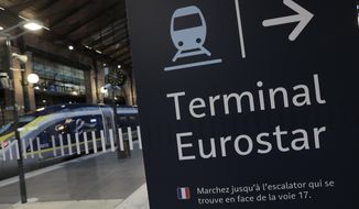 An information board is displayed at Gare du Nord train station in Paris, Monday Dec. 21, 2020, next to a Eurostar train. (AP Photo/Lewis Joly) ** FILE **