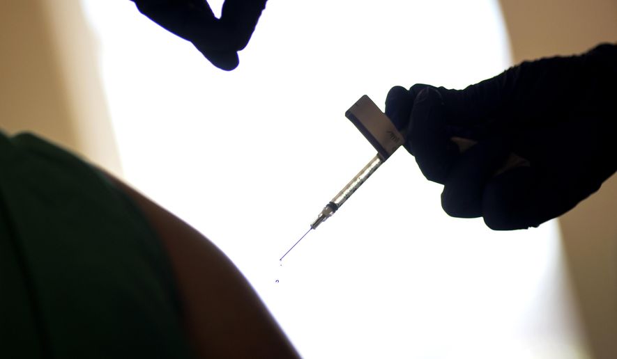 In this Tuesday, Dec. 15, 2020, file photo, a droplet falls from a syringe after a health care worker is injected with the Pfizer-BioNTech COVID-19 vaccine at Women &amp;amp; Infants Hospital in Providence, R.I. The Vatican has declared it “morally acceptable” for Roman Catholics to receive COVID-19 vaccines based on research that used fetal tissue from abortions. The Vatican’s watchdog office for doctrinal orthodoxy said Monday that it addressed the question after receiving requests for guidance. (AP Photo/David Goldman, File) ** FILE **