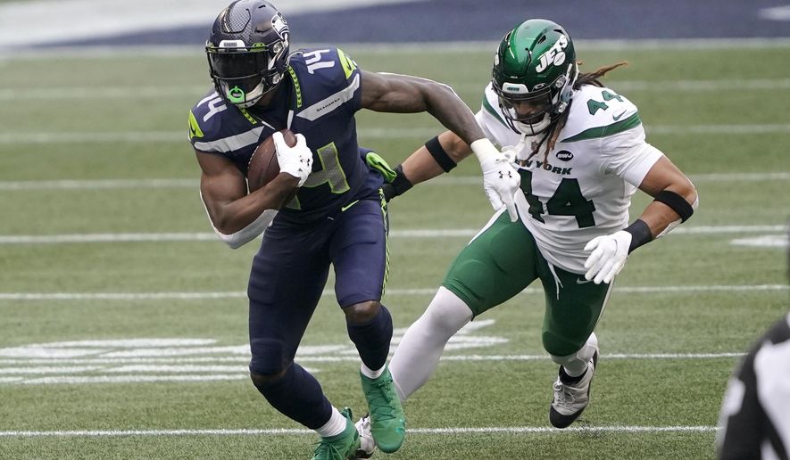 Seattle Seahawks wide receiver DK Metcalf (14) runs with the ball as New York Jets inside linebacker Harvey Langi gives chase during the first half of an NFL football game, Sunday, Dec. 13, 2020, in Seattle. (AP Photo/Ted S. Warren)