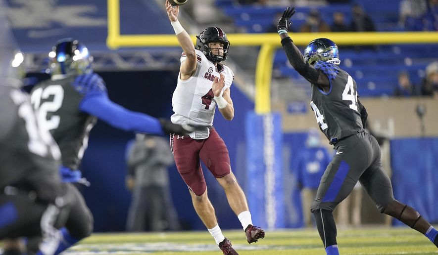 South Carolina quarterback Luke Doty (4) throws a pass during the second half of the team's NCAA college football game against Kentucky, Saturday, Dec. 5, 2020, in Lexington, Ky. (AP Photo/Bryan Woolston)