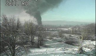 A Washington state Department of Transportation traffic camera captures an image of a train that derailed north of Seattle, close to the Canadian border on Tuesday, Dec. 22, 2020. Authorities say it was carrying crude oil. (Washington State Department of Transportation via AP)