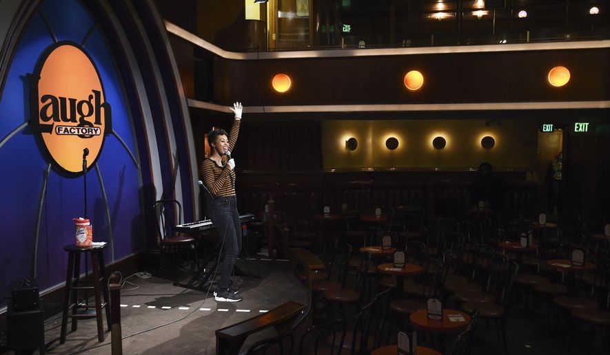 Comedian Daphnique Springs performs to an empty room during a "Laughter is Healing" stand-up comedy livestream event at the Laugh Factory comedy club, Monday, April 20, 2020, in Los Angeles. (AP Photo/Chris Pizzello)