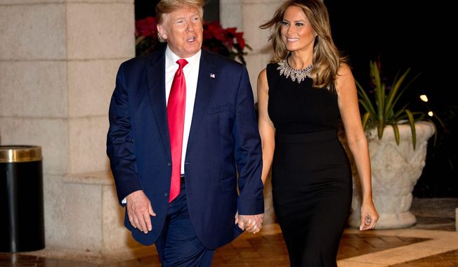 One year ago: President Trump and first lady Melania Trump arrive for Christmas Eve dinner at Mar-a-Lago in Palm Beach, Florida. (Associated Press)