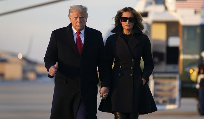 President Donald Trump and first lady Melania Trump board Air Force One at Andrews Air Force Base, Md., Wednesday, Dec. 23, 2020. Trump is traveling to his Mar-a-Lago resort in Palm Beach, Fla. (AP Photo/Patrick Semansky)