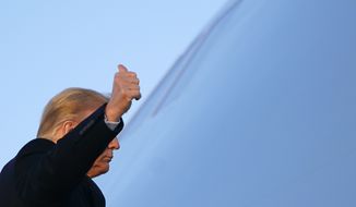 President Donald Trump gestures as he boards Air Force One at Andrews Air Force Base, Md., Wednesday, Dec. 23, 2020. Trump is traveling to his Mar-a-Lago resort in Palm Beach, Fla. (AP Photo/Patrick Semansky)