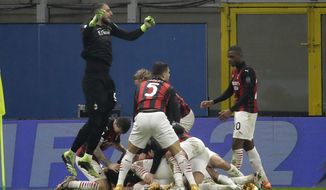 AC Milan players celebrate the third goal against Lazio form their teammate Theo Hernandez during a Serie A soccer match between AC Milan and Lazio, at the San Siro stadium in Milan, Italy, Wednesday, Dec. 23, 2020. (AP Photo/Luca Bruno)