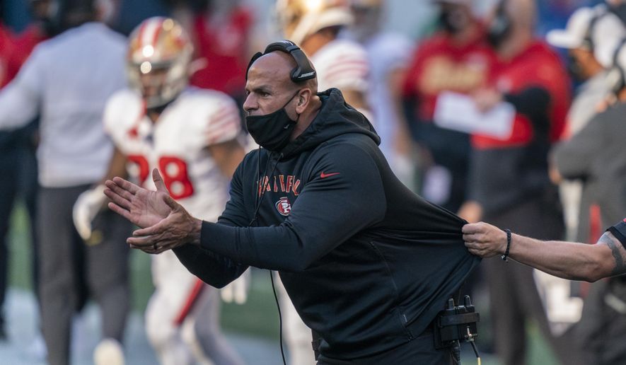 FILE - In this Nov. 1, 2020, file photo, San Francisco 49ers defensive coordinator Robert Saleh cheers on his team from the sideline during the first half of an NFL football game against the Seattle Seahawks in Seattle. One year ago, Saleh and Kansas City Chiefs offensive coordinator Eric Bieniemy missed out on the coaching carousel despite being coordinators of the two Super Bowl teams. The two figure to be near the top of many of the lists of possible head coaching candidates again this offseason when the NFL is hoping some new rules lead to more opportunities for minority coaches.(AP Photo/Stephen Brashear, File)