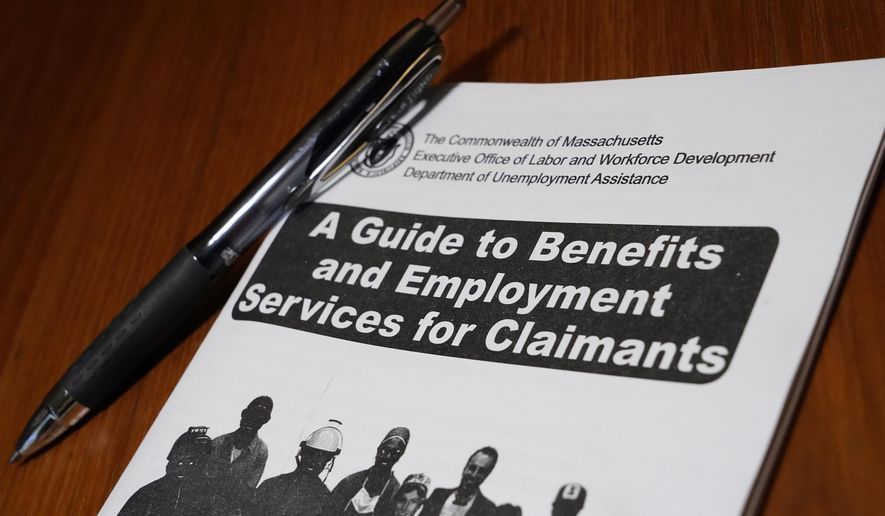In this Thursday, Nov. 5, 2020, file photo, a booklet describing unemployment benefits is seen on a desk, in North Andover, Mass. (AP Photo/Elise Amendola, File)