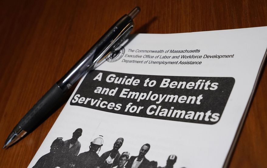 In this Thursday, Nov. 5, 2020, file photo, a booklet describing unemployment benefits is seen on a desk, in North Andover, Mass. (AP Photo/Elise Amendola, File)