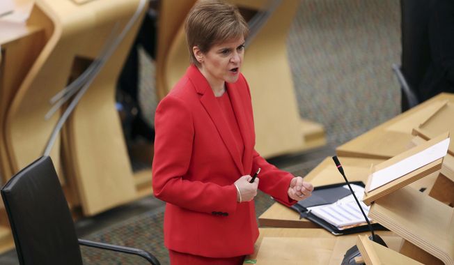 Scotland&#x27;s First Minister Nicola Sturgeon gives an update on COVID-19 restrictions, at the Scottish Parliament in Edinburgh, Scotland, Tuesday Dec. 22, 2020.  Scotland has imposed some increased restrictions for the Christmas season. (Russell Cheyne/PA via AP)