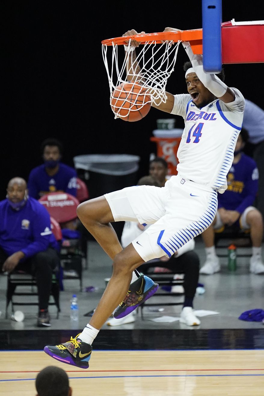 DePaul's Nick Ongenda dunks the ball during the first half of an NCAA college basketball game against Western Illinois, Wednesday, Dec. 23, 2020, in Chicago. (AP Photo/Charles Rex Arbogast)
