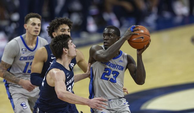 Creighton forward Damien Jefferson (23) drives to the basket against Xavier forward Zach Freemantle (32) in the second half during an NCAA college basketball game on Wednesday, Dec. 23, 2020, in Omaha, Neb. (AP Photo/John Peterson)