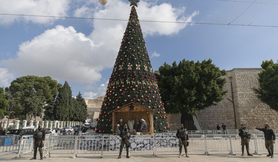 A Palestinian National security unit is deployed in Manger Square, adjacent to the Church of the Nativity, traditionally believed by Christians to be the birthplace of Jesus Christ, ahead of Christmas, in the West Bank city of Bethlehem, Wednesday, Dec. 23, 2020. (AP Photo/Nasser Nasser)