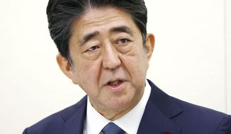 Former Japanese Prime Minister Shinzo Abe speaks during a press conference in Tokyo, Thursday, Dec. 24, 2020. Abe offered his deep apologizes on Thursday over illegal expenses linked to a dinner party his office hosted for his supporters ahead of an annual cherry blossom viewing party.(Kyodo News via AP)