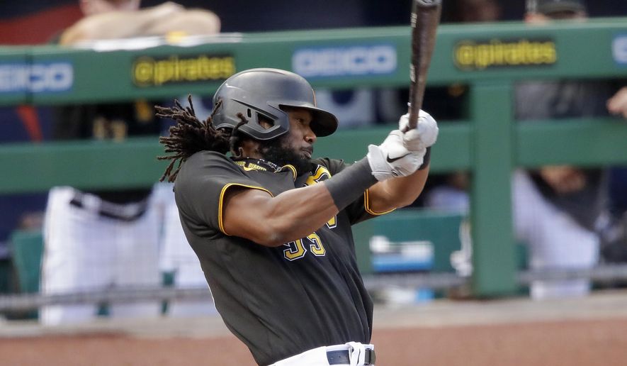 FILE - In this July 22, 2020, file photo, Pittsburgh Pirates&#x27; Josh Bell bats during an exhibition baseball game against the Cleveland Indians in Pittsburgh. The Pirates traded the slugging first baseman to Washington on Thursday, Dec. 24, 2020, for pitching prospects Will Crowe and Eddy Yean. (AP Photo/Gene J. Puskar, File)