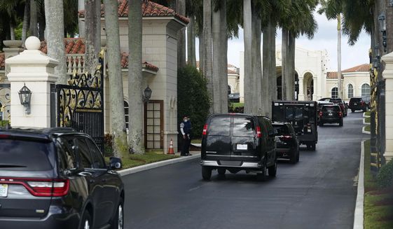 President Donald Trump&#x27;s motorcade arrives at Trump International Golf Club, Thursday, Dec. 24, 2020, in West Palm Beach, Fla. (AP Photo/Patrick Semansky)