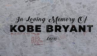 File-This Jan. 28, 2020, file photo shows a remembrance board at a memorial for Kobe Bryant near Staples Center in Los Angeles. Bryant, the 18-time NBA All-Star who won five championships and became one of the greatest basketball players of his generation during a 20-year career with the Los Angeles Lakers, died in a helicopter crash Sunday. (AP Photo/Ringo H.W. Chiu, File)