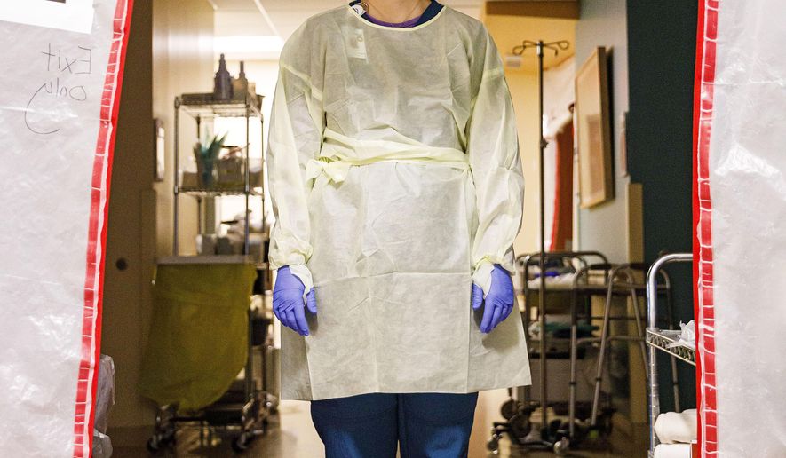 Nurse practitioner Sara Becker stands in a negative pressure space in the respiratory unit where COVID-19 patients are treated at West Park Hospital in Cody, Wyo. on Friday, Dec. 18, 2020. Negative pressure spaces pull out contaminants in the air and allow in fresh air. (Lauren Modler/The Cody Enterprise via AP)