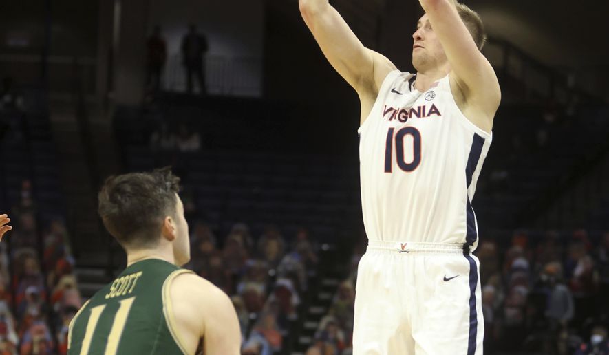 Virginia forward Sam Hauser (10) shoots over William & Mary guard Thornton Scott (11) during an NCAA college basketball game Tuesday, Dec. 22, 2020, in Charlottesville, Va. (Andrew Shurtleff/The Daily Progress via AP)