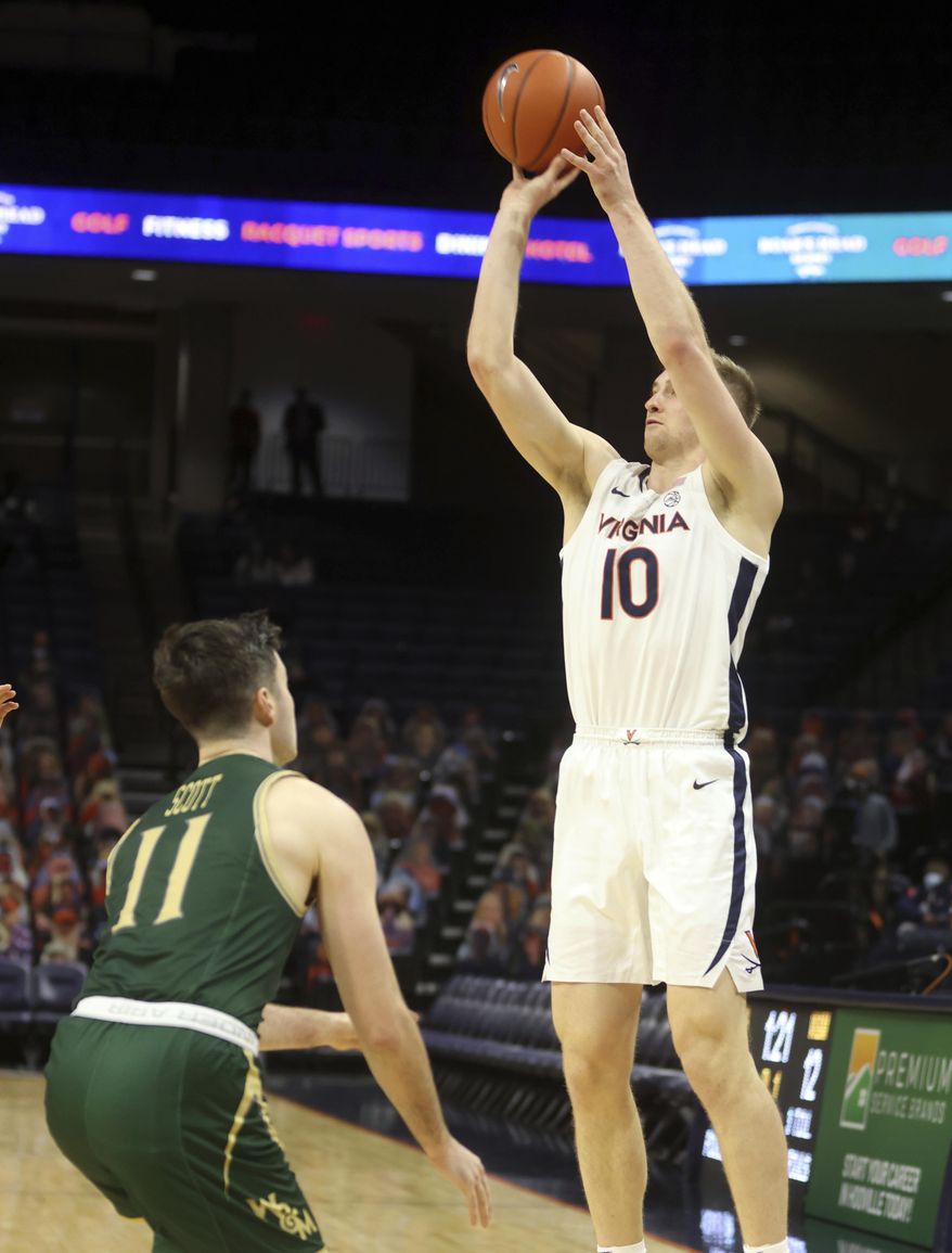 Virginia forward Sam Hauser (10) shoots over William & Mary guard Thornton Scott (11) during an NCAA college basketball game Tuesday, Dec. 22, 2020, in Charlottesville, Va. (Andrew Shurtleff/The Daily Progress via AP)