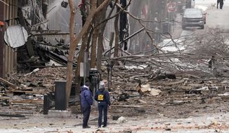 Emergency personnel work near the scene of an explosion in downtown Nashville, Tenn., Friday, Dec. 25, 2020. Buildings shook in the immediate area and beyond after a loud boom was heard early Christmas morning.(AP Photo/Mark Humphrey) ** FILE **