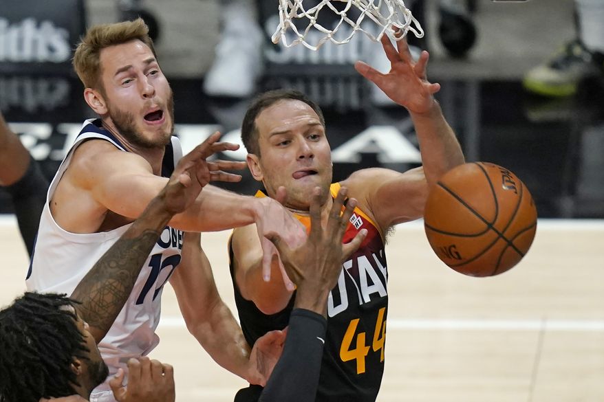 Minnesota Timberwolves forward Jake Layman, left, and Utah Jazz forward Bojan Bogdanovic (44) compete for a rebound during the first half of an NBA basketball game Saturday, Dec. 26, 2020, in Salt Lake City. (AP Photo/Rick Bowmer)