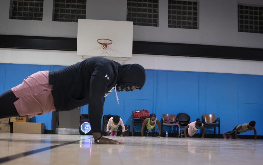 Chris Edmonds, a Woodland High School graduate and former NFL player, teaches fitness classes to a chronically underserved population in Braddock, Pa., Thursday, Dec. 10, 2020. (Steve Mellon/Pittsburgh Post-Gazette via AP)