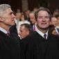 In this Feb. 5, 2019 file photo, Supreme Court Associate Justices Neil Gorsuch, left, and Brett Kavanaugh watch as President Donald Trump arrives to give his State of the Union address to a joint session on Congress at the Capitol in Washington. (Doug Mills/The New York Times via AP, Pool, File)