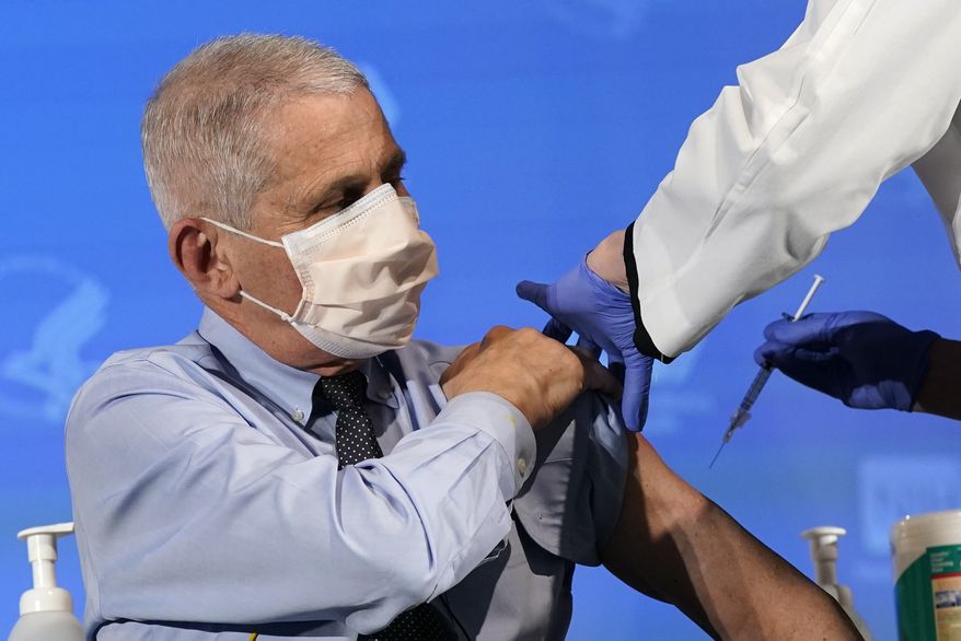 In this Dec. 22, 2020, file photo Dr. Anthony Fauci, director of the National Institute of Allergy and Infectious Diseases, prepares to receive his first dose of the COVID-19 vaccine at the National Institutes of Health in Bethesda, Md. (AP Photo/Patrick Semansky, Pool, File)