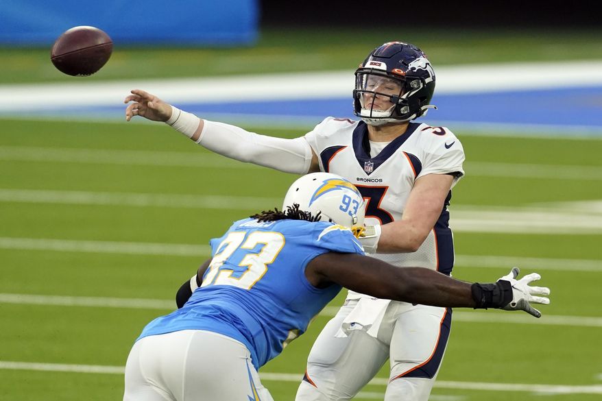 Denver Broncos quarterback Drew Lock (3) throws under pressure from Los Angeles Chargers defensive tackle Justin Jones during the second half of an NFL football game Sunday, Dec. 27, 2020, in Inglewood, Calif. (AP Photo/Ashley Landis)