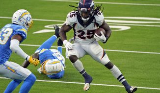 Denver Broncos running back Melvin Gordon (25) runs against the Los Angeles Chargers during the second half of an NFL football game Sunday, Dec. 27, 2020, in Inglewood, Calif. (AP Photo/Ashley Landis)