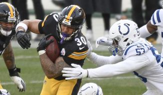 Pittsburgh Steelers running back James Conner (30) runs away from Indianapolis Colts defensive end Kemoko Turay (57) during the second half of an NFL football game, Sunday, Dec. 27, 2020, in Pittsburgh. (AP Photo/Don Wright)