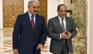 FILE - In this May 9, 2019 file photo, provided by Egypt&#x27;s presidency media office, Egyptian President Abdel-Fattah el-Sissi, right, walks with military commander Khalifa Hifter, the head of the self-styled Libyan National Army, in Cairo, Egypt. Diplomats and intelligence officials from Egypt arrived in Libya’s capital, Tripoli on Sunday, Dec. 27, 2020, the most senior Egyptian delegation to visit the western part of the north African country in years. Egypt views the instability in neighboring Libya as a national security threat and has backed Hifter who controls eastern and southern Libya, and attempted to seize Tripoli in a campaign collapsed earlier this year after Turkey&#x27;s heavy military support to his rivals in Tripoli. (Egyptian Presidency Media office via AP, File)