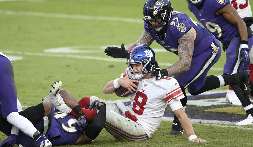 New York Giants quarterback Daniel Jones (8) is sacked by Baltimore Ravens linebacker Chris Board, let, as defensive end Derek Wolfe (95) helps bring him down during the second half of an NFL football game, Sunday, Dec. 27, 2020, in Baltimore. The Ravens won 27-13. (AP Photo/Nick Wass)