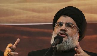 In this Nov. 3, 2014 file photo, Hezbollah leader Hassan Nasrallah addresses supporters in the southern suburb of Beirut, Lebanon. The Hezbollah leader said Tuesday, Sept. 29, 2020, they still welcome the French initiative to help Lebanon out of its crisis, but said Paris has to change its approach in dealing with local factions and not blame everyone for the failure of forming a new Cabinet. (AP Photo/Hussein Malla, File)