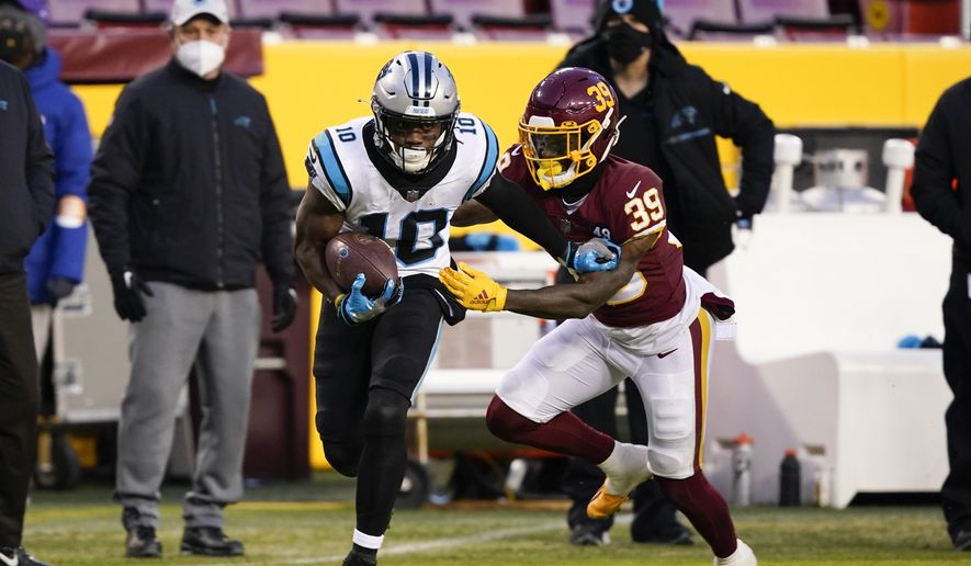 Carolina Panthers wide receiver Curtis Samuel (10) runs with the ball as he is chased by Washington Football Team defensive back Jeremy Reaves (39) during the first half of an NFL football game, Sunday, Dec. 27, 2020, in Landover, Md. (AP Photo/Susan Walsh) **FILE**