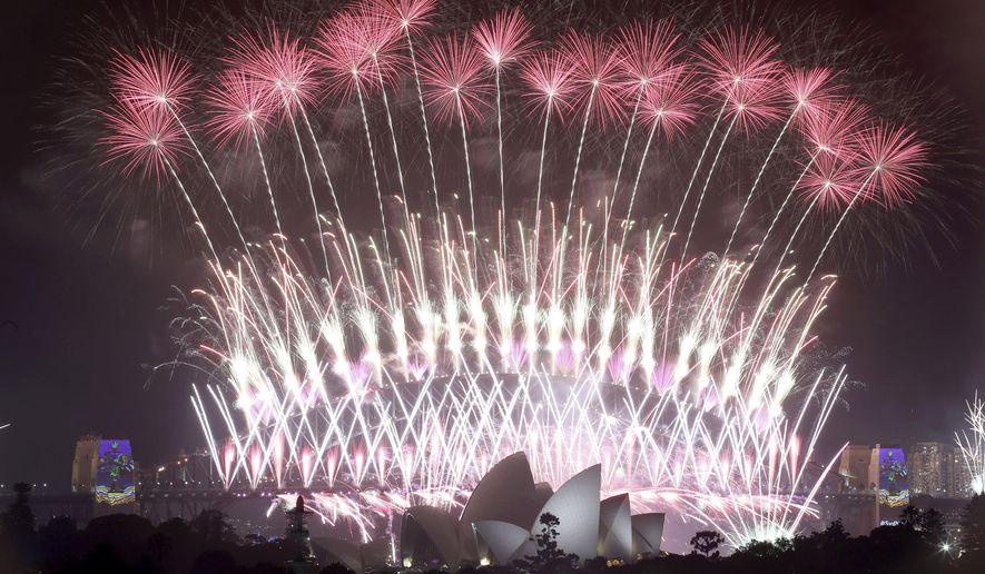 FILE - In this Jan. 1, 2017, file photo, fireworks explode over the Sydney Opera House and Harbour Bridge as New Year's celebrations are underway in Sydney. Authorities have banned New Year’s Eve revelers from congregating in Sydney’s downtown harborside to see the celebrated fireworks due to the pandemic risk. New South Wales state Premier Gladys Berejiklian said on Monday, Dec. 28, 2020, people who live in the city center can invite up to 10 guests to their homes to celebrate. The guests will have to apply for permits to enter the area.(AP Photo/Rick Rycroft, File)