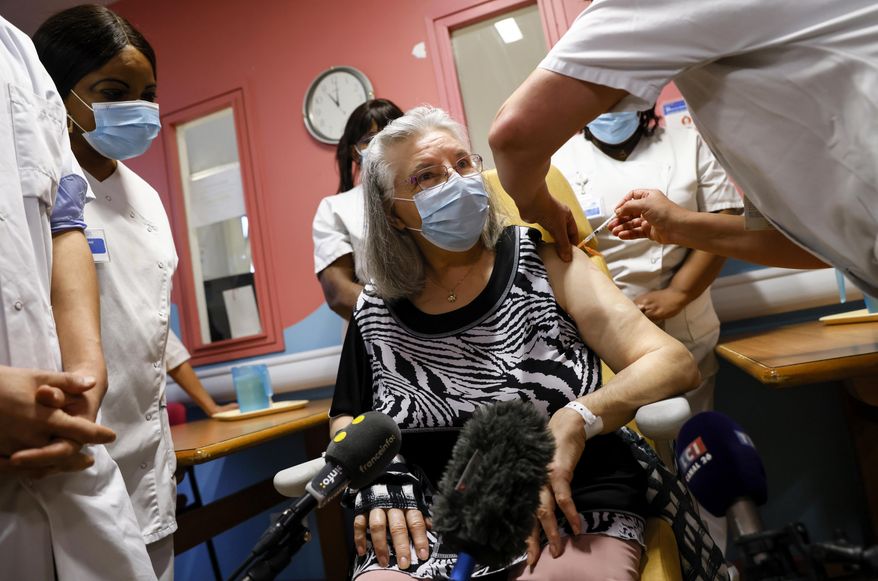 Mauricette, a French 78-year-old woman, is the first to get vaccinated for COVID-19 at the Rene-Muret hospital in Servan near Paris, Sunday Dec. 27, 2020. France is starting its first vaccinations Sunday against the coronavirus at a nursing home northeast of Paris, in one of France's poorest regions. (Thomas Samson/Pool Photo via AP)