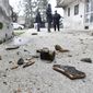 Residents inspect damage caused by an earthquake in Sisak, Croatia, Monday, Dec. 28, 2020. A moderate earthquake has hit central Croatia near its capital of Zagreb, triggering panic and some damage south of the city. There were no immediate reports of injuries. (AP Photo)