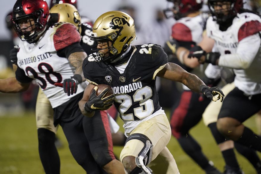 FILE - In this Nov. 28, 2020, file photo, Colorado running back Jarek Broussard, front, runs for a short gain as San Diego State linebacker Andrew Aleki pursues during the second half of an NCAA college football game in Boulder, Colo. Broussard is one of the top rushers in the country averaging nearly 163 yards per game. (AP Photo/David Zalubowski, File)