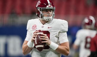 Alabama quarterback Mac Jones (10) warms up before the first half of the Southeastern Conference championship NCAA college football game against Florida, Saturday, Dec. 19, 2020, in Atlanta. Heisman Trophy finalists Mac Jones and DeVonta Smith have been selected to The Associated Press All-America team, Monday, Dec. 28, 2020, leading a contingent of five Alabama players on the first-team offense. (AP Photo/Brynn Anderson)