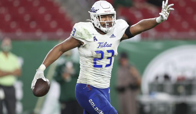 FILE - Tulsa linebacker Zaven Collins (23) celebrates after scoring a touchdown during an NCAA football game in Tampa, Fla., in this Oct. 23, 2020, file photo. Collins was selected to The Associated Press All-America first-team defense, Monday, Dec. 28, 2020. (AP Photo/Mark LoMoglio, File)