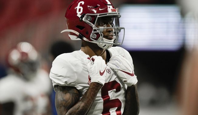 Alabama wide receiver DeVonta Smith (6) warms up before the first half of the Southeastern Conference championship NCAA college football game against Florida, Saturday, Dec. 19, 2020, in Atlanta. Heisman Trophy finalists Mac Jones and DeVonta Smith have been selected to The Associated Press All-America team, Monday, Dec. 28, 2020, leading a contingent of five Alabama players on the first-team offense. (AP Photo/Brynn Anderson)