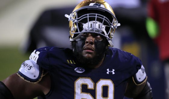 FILE - Notre Dame offensive lineman Aaron Banks (69) looks into the stands as he walks off the field following their loss to Clemson at the Atlantic Coast Conference championship NCAA college football game in Charlotte, N.C., in this Saturday, Dec. 19, 2020, file photo. Banks was selected to The Associated Press All-America first-team, Monday, Dec. 28, 2020. (AP Photo/Brian Blanco, File)